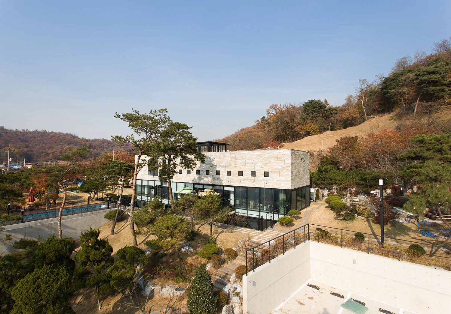 Daytime view of the Gate House main building within the sloping landscape.