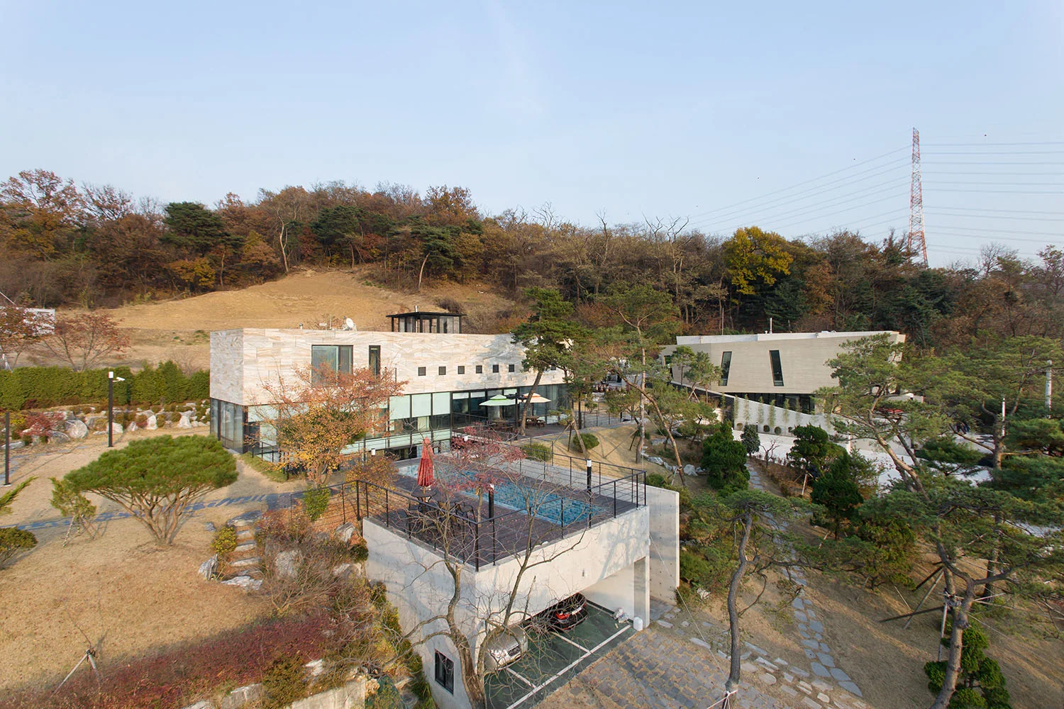 Daytime overview of the two Gate House buildings and their landscaped setting.