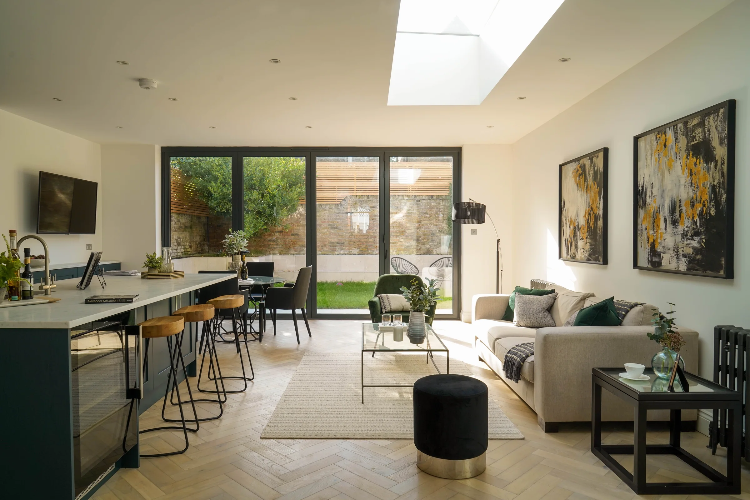 Open-plan kitchen and sitting room extending towards garden glazing at Gorst Road.