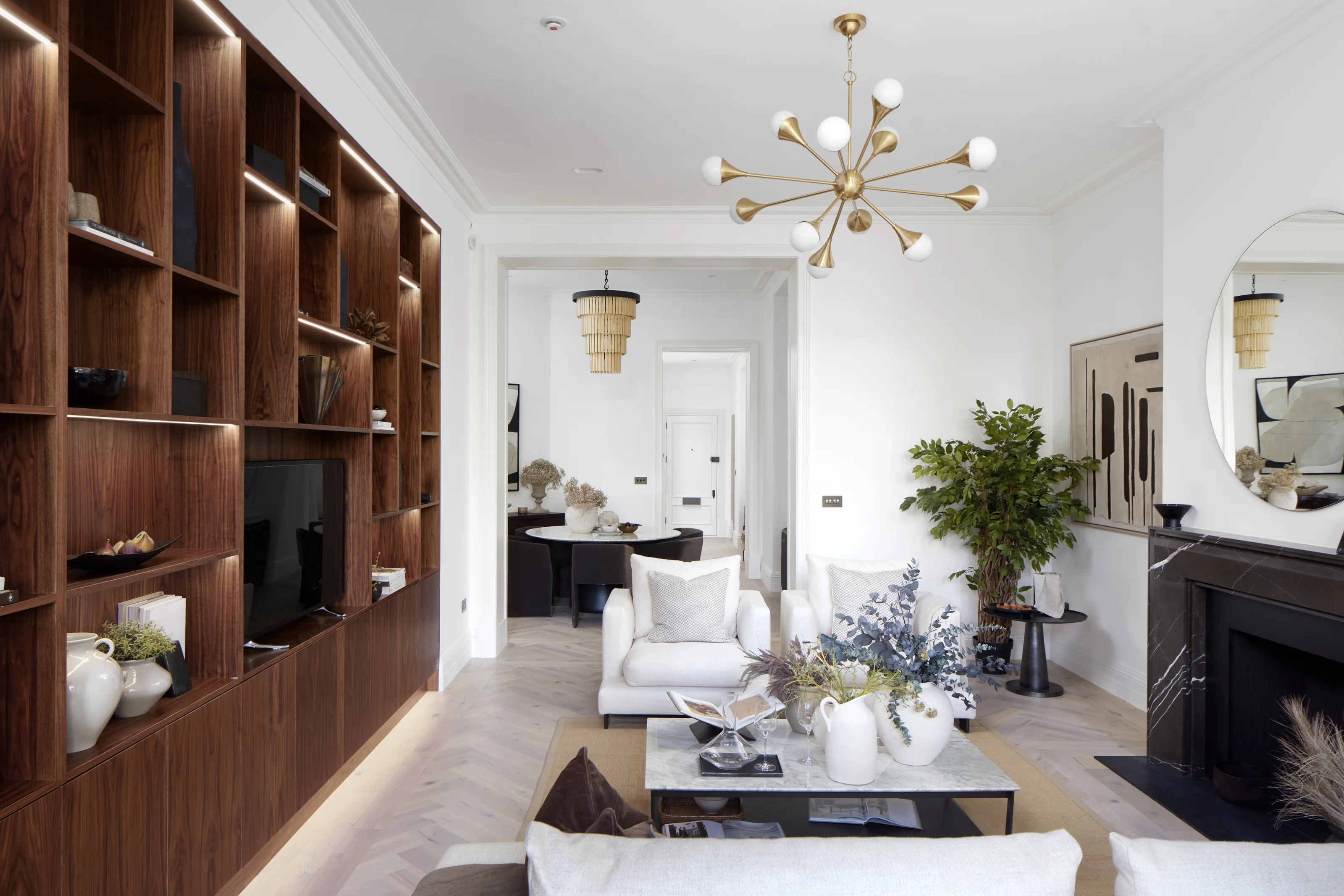 Wellington Court: connected sitting and dining rooms, timber joinery and pale herringbone flooring.